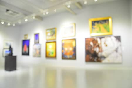 Various paintings framed in an art gallery